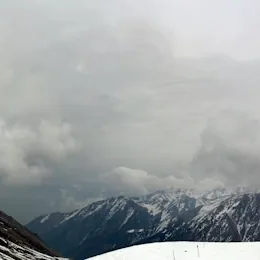 A man riding skis down a snow covered slope, Almaty
