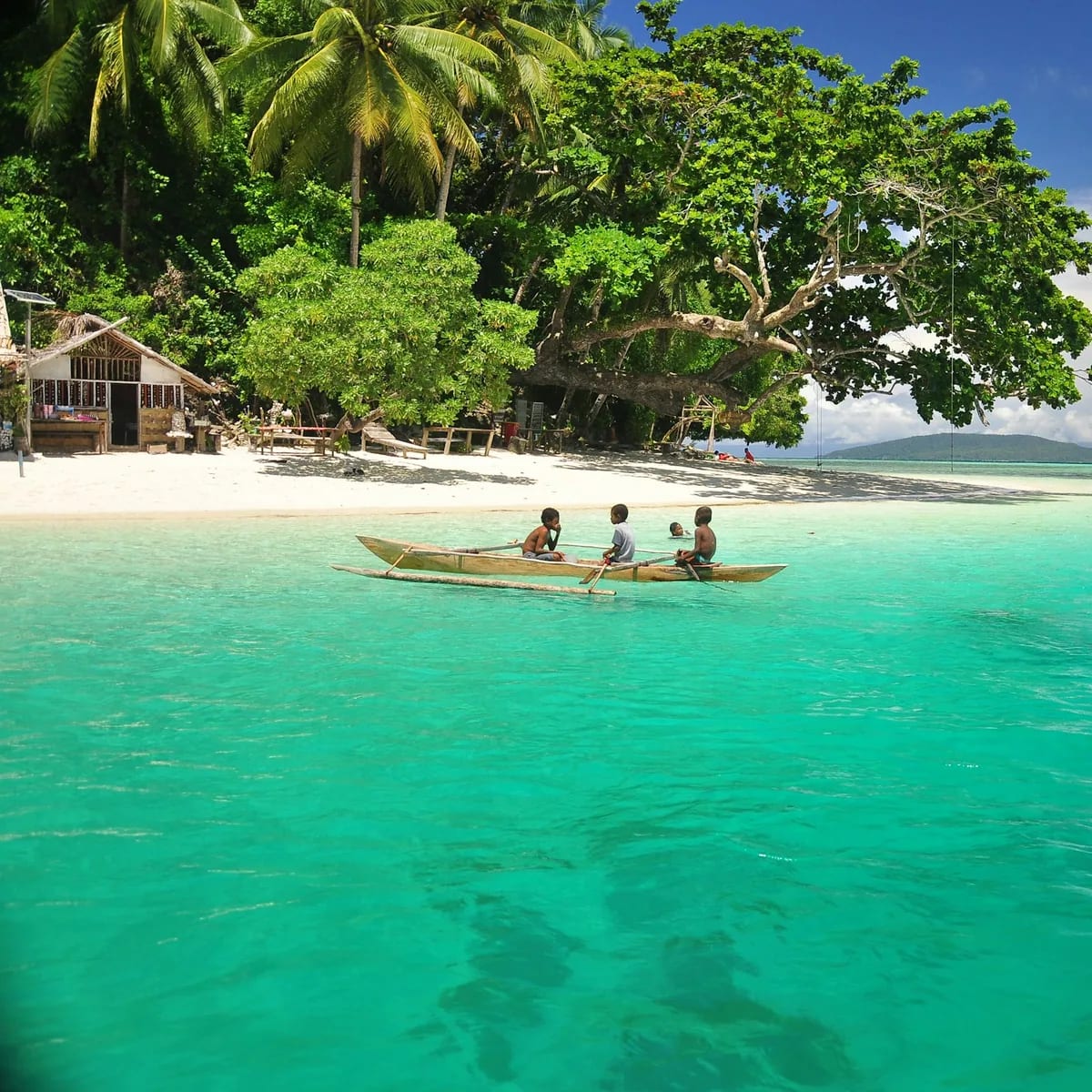 A couple of people in a small boat in the water, Andaman