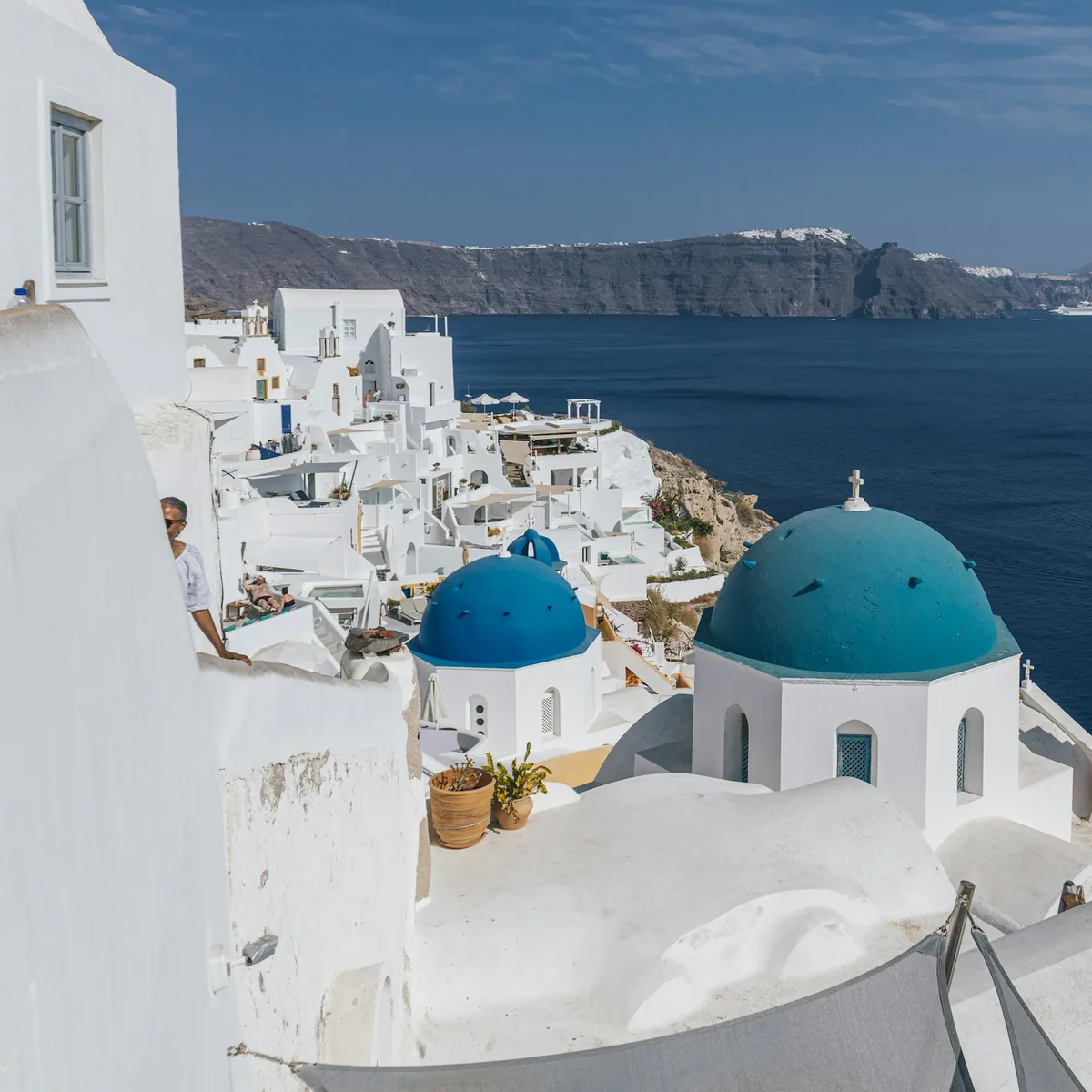 A white building with a blue dome on the top of it, Greece