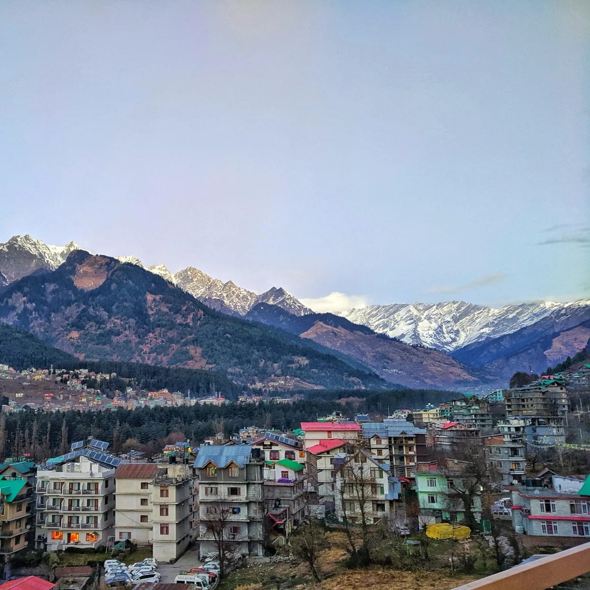 A view of a city with mountains in the background, Manali
