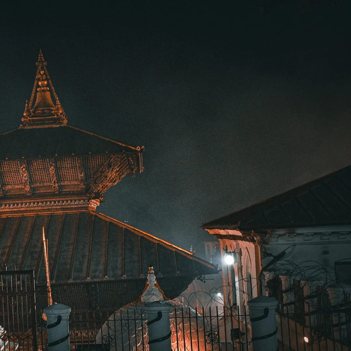 A tall building with a clock on the top of it, Nepal
