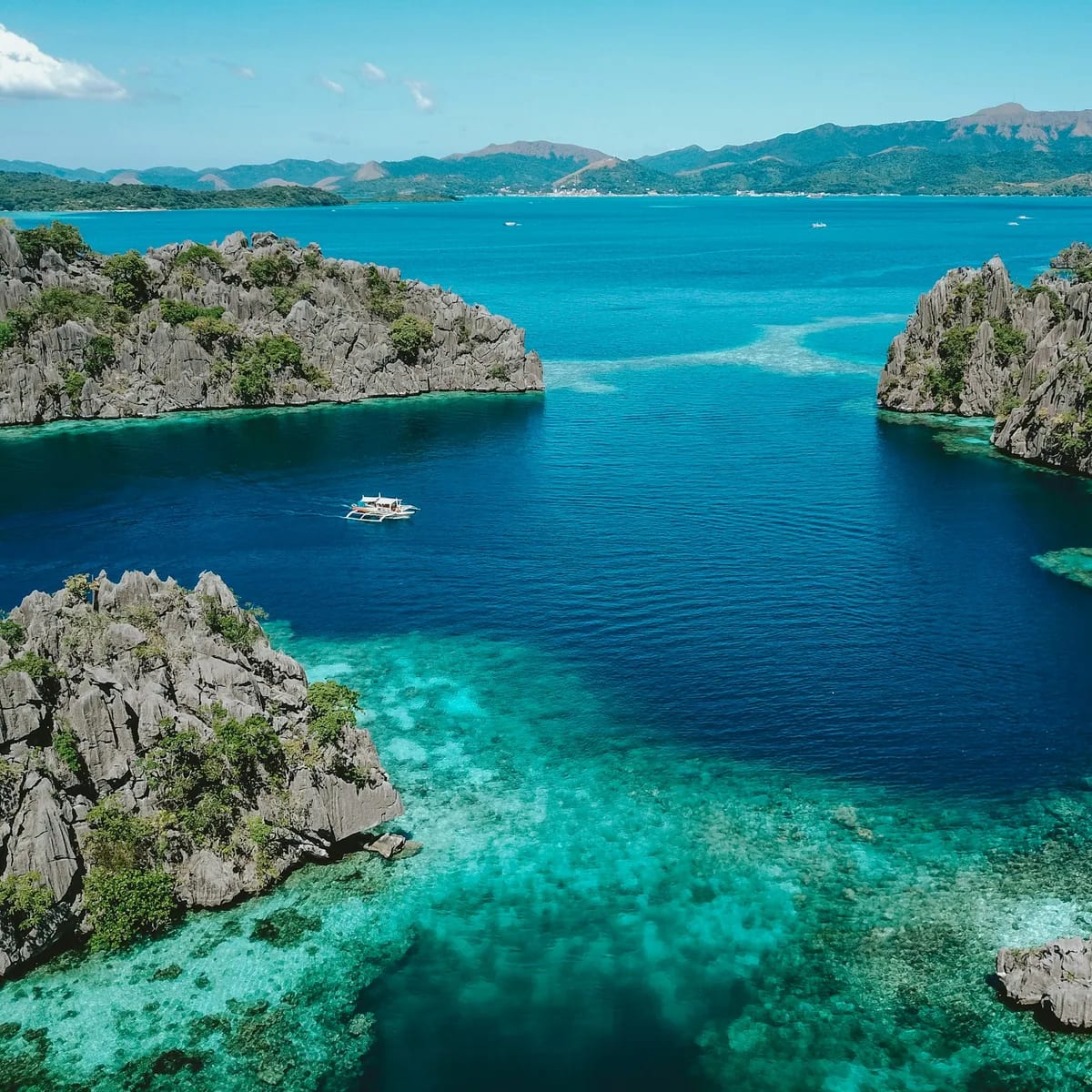 Aerial photo of clear blue sea surrounded by mountains, Philippines