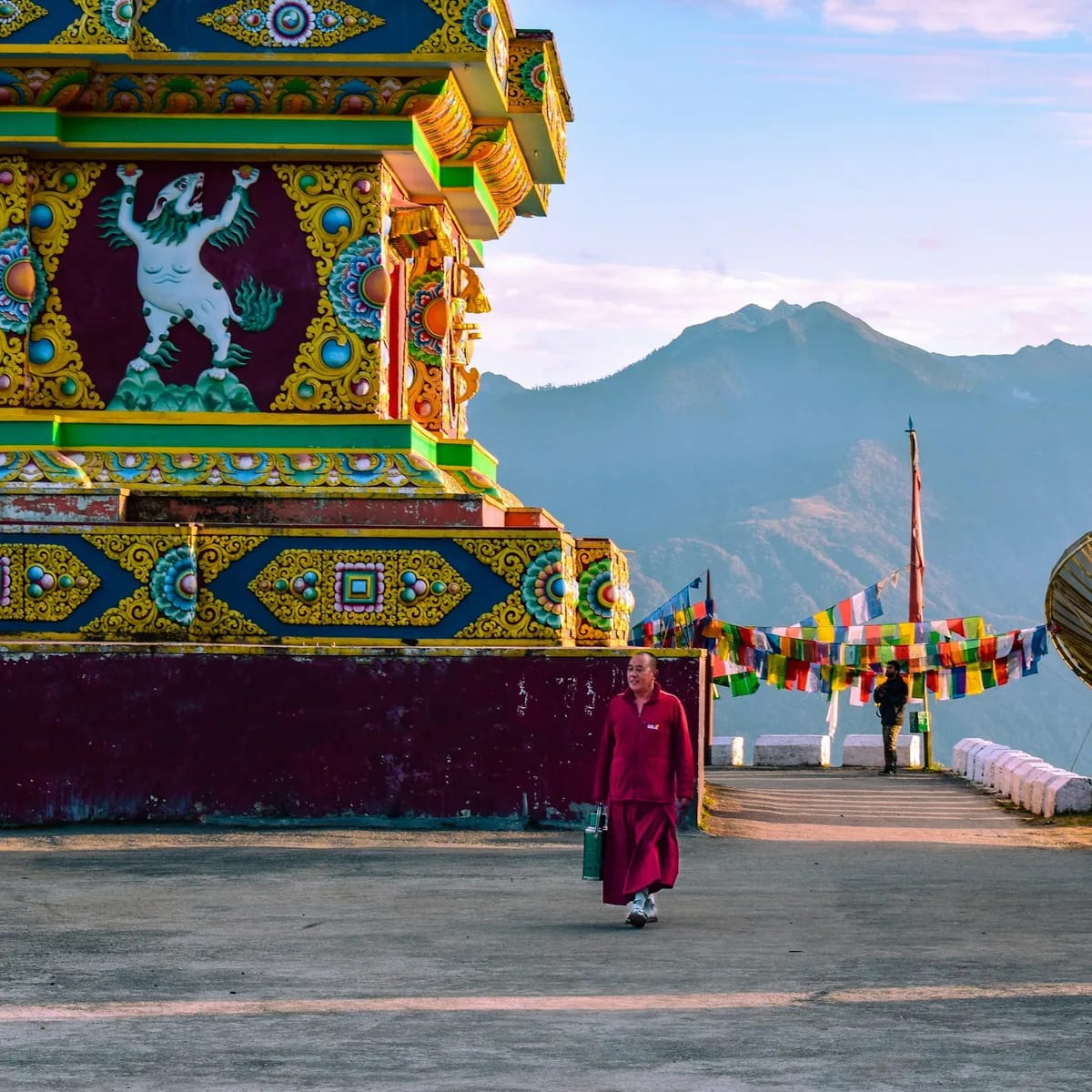 People walking on street near red and yellow temple during…, Dharamshala