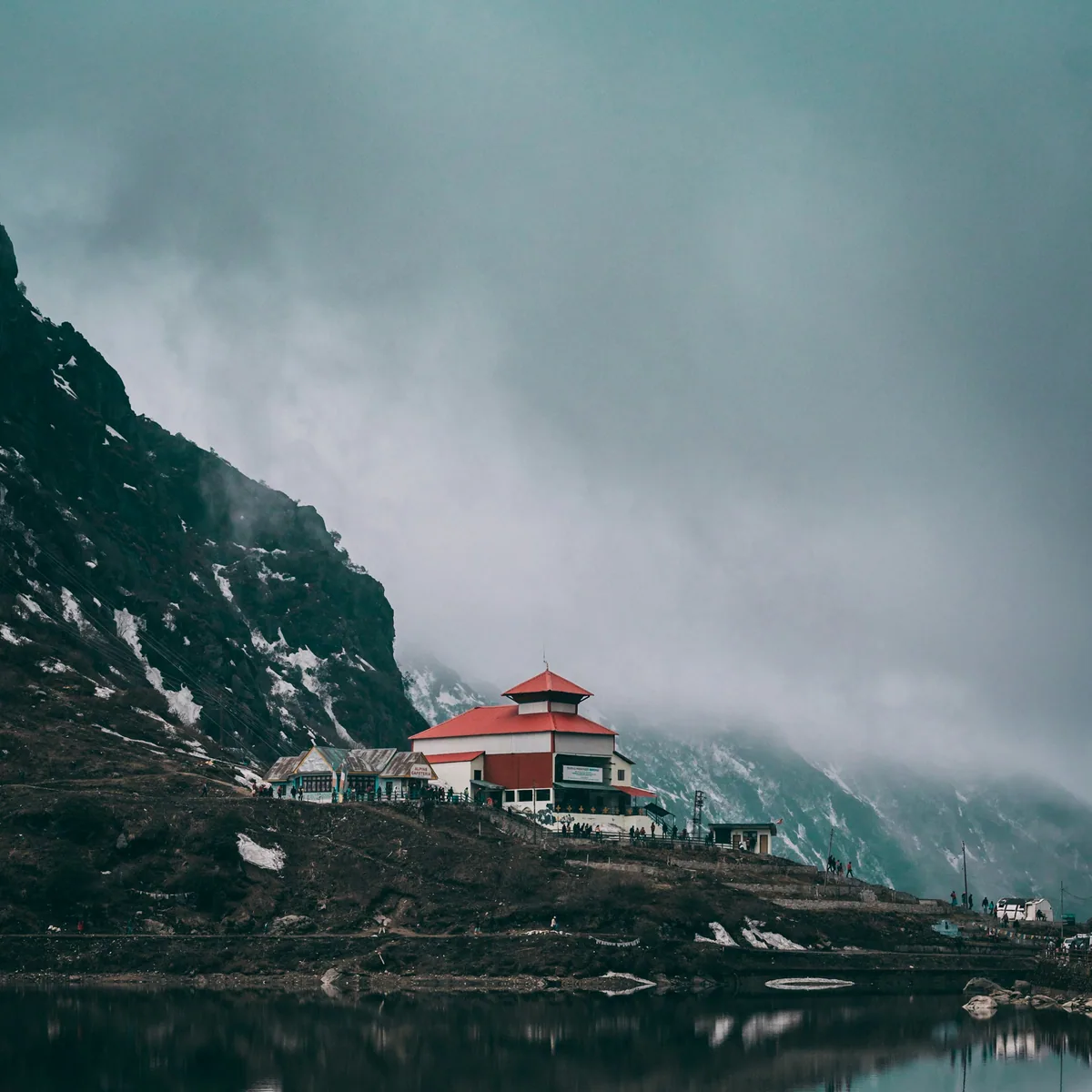 White and red concrete building near body of water, Sikkim