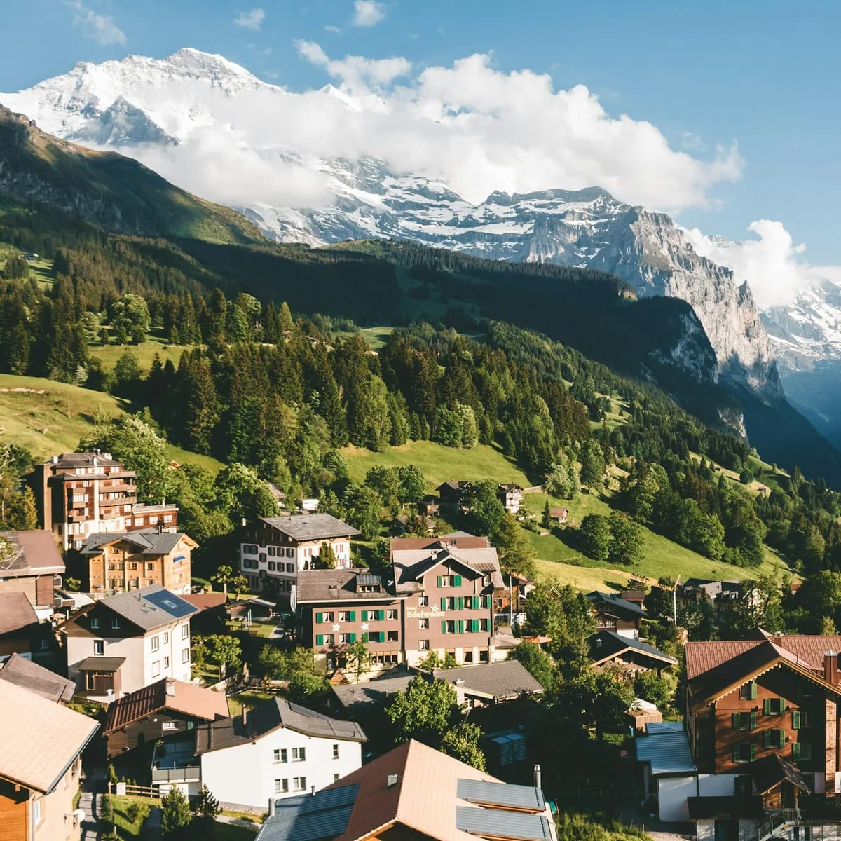 Brown and white houses on green mountain under blue sky dur…, Switzerland