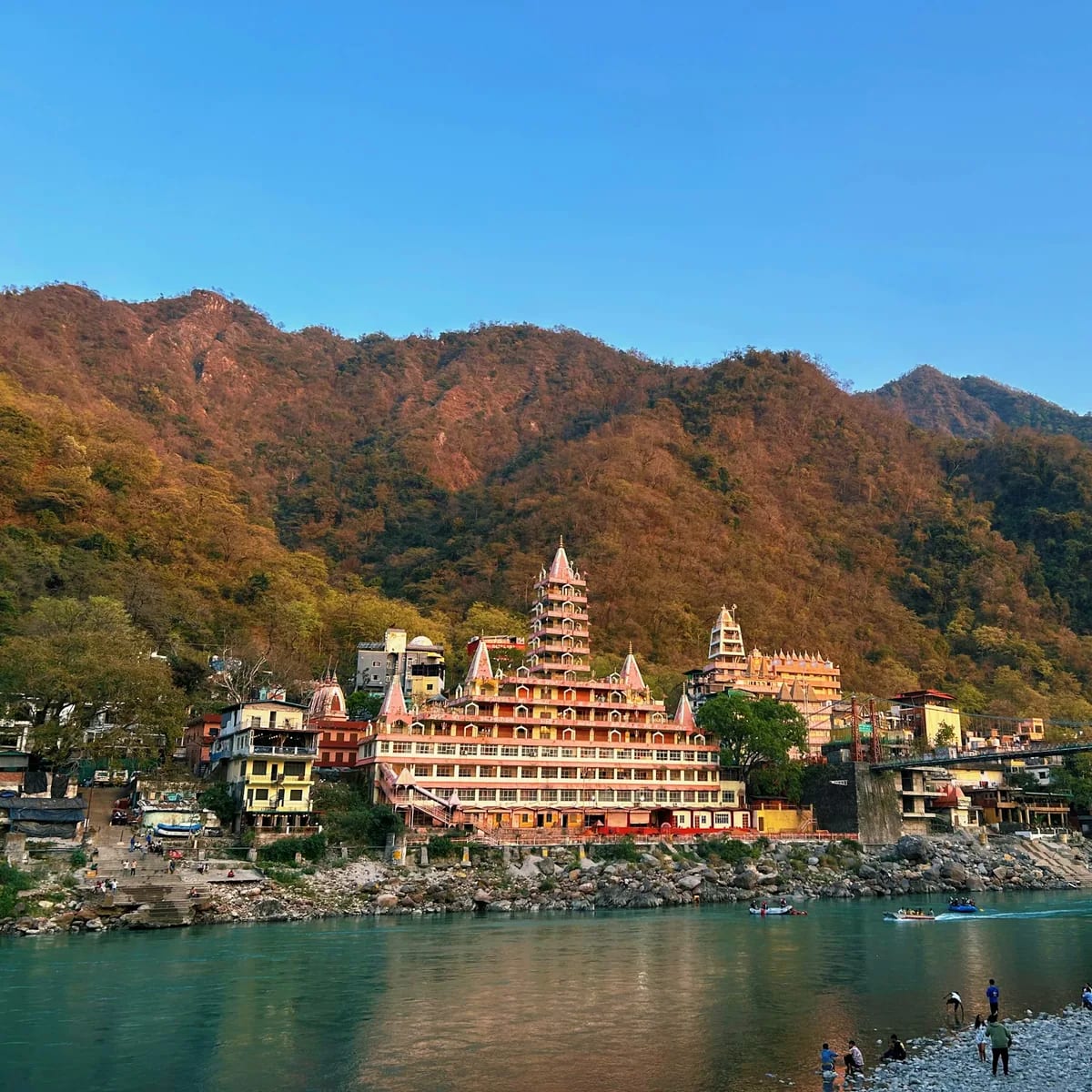 A scenic view of a mountain town with a river running throu…, Mussoorie & Rishikesh