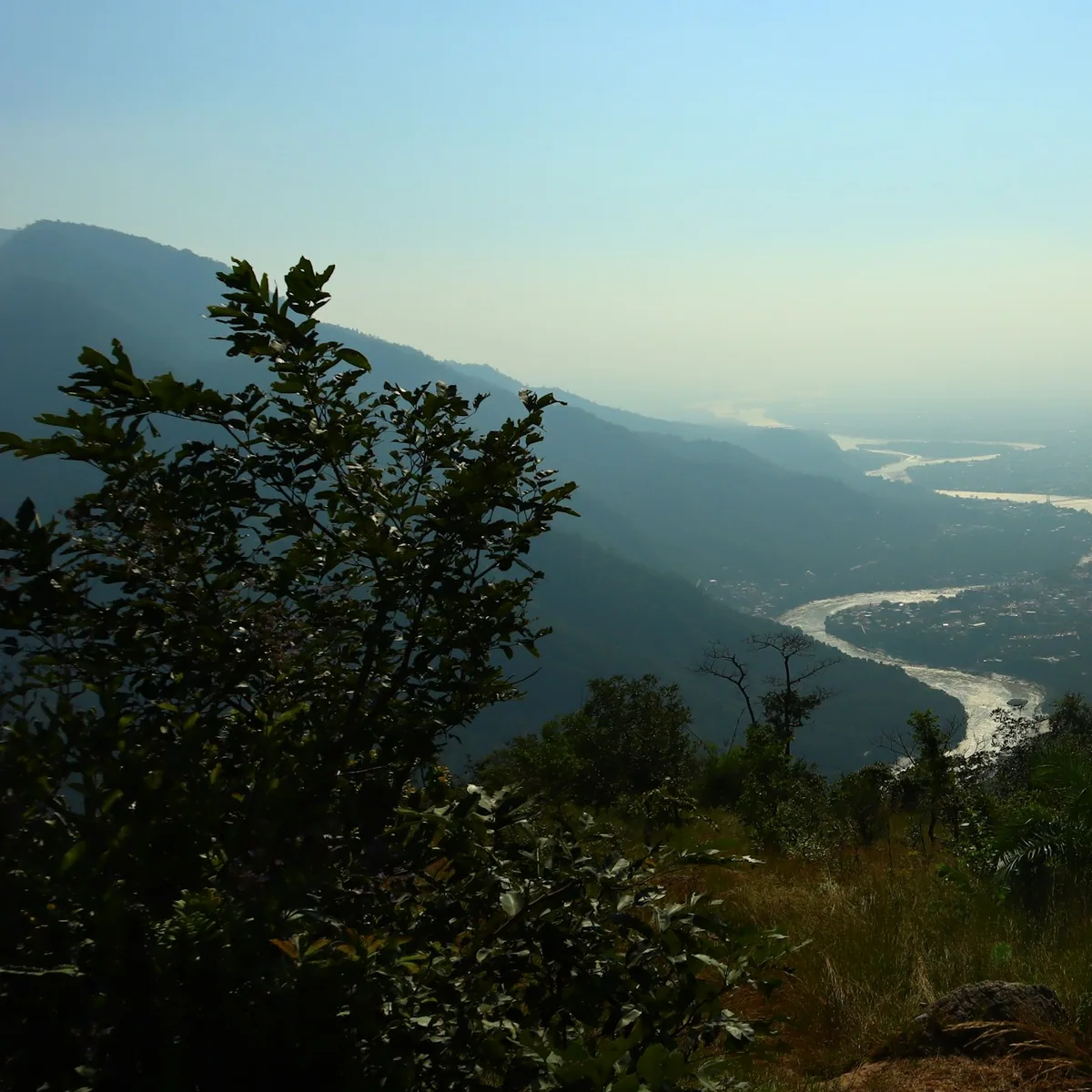 A river flowing through a valley surrounded by mountains, Mussoorie & Rishikesh
